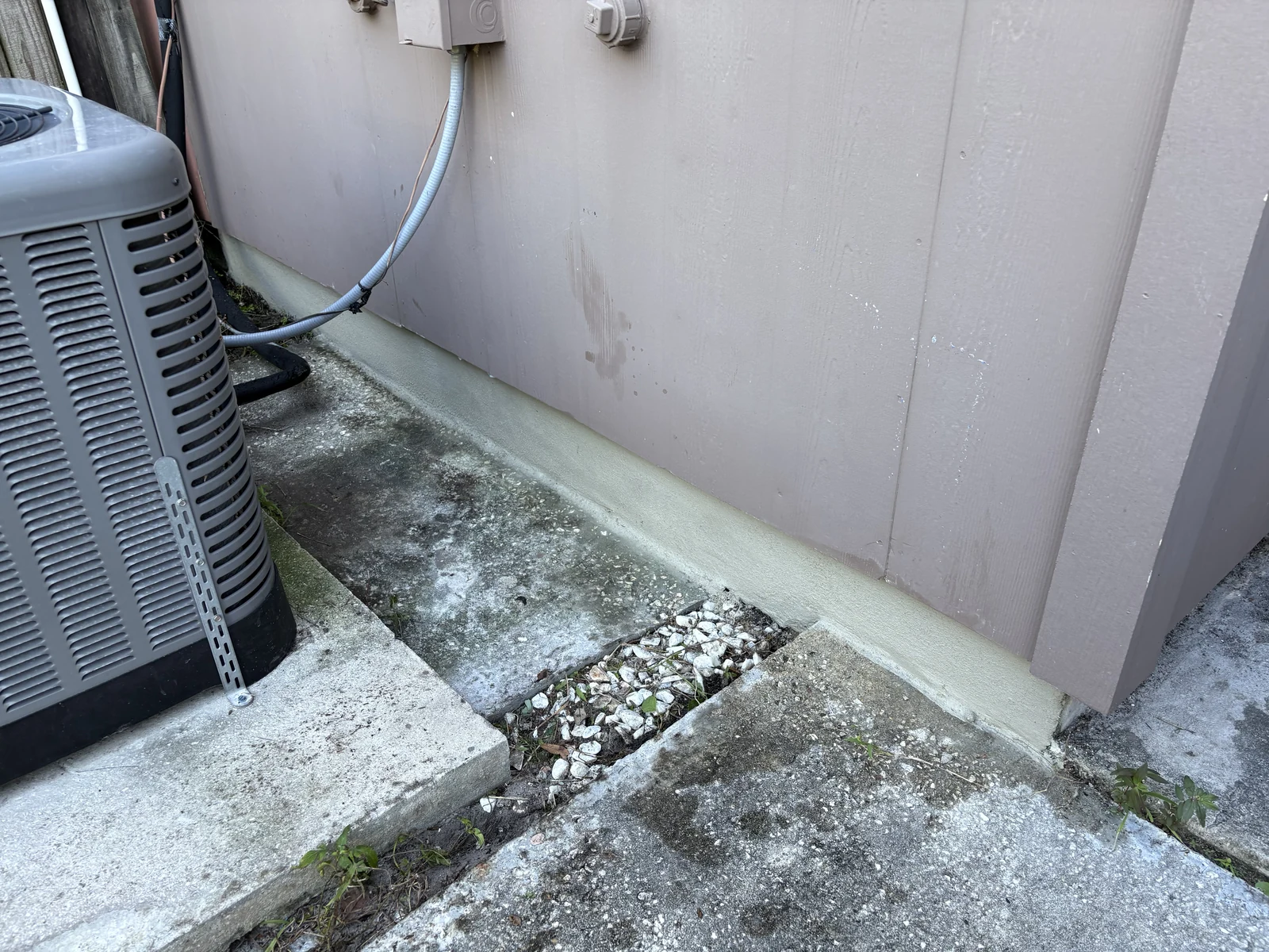 Stucco Coating Along Foundation Slab Edge on Residential Exterior Wall